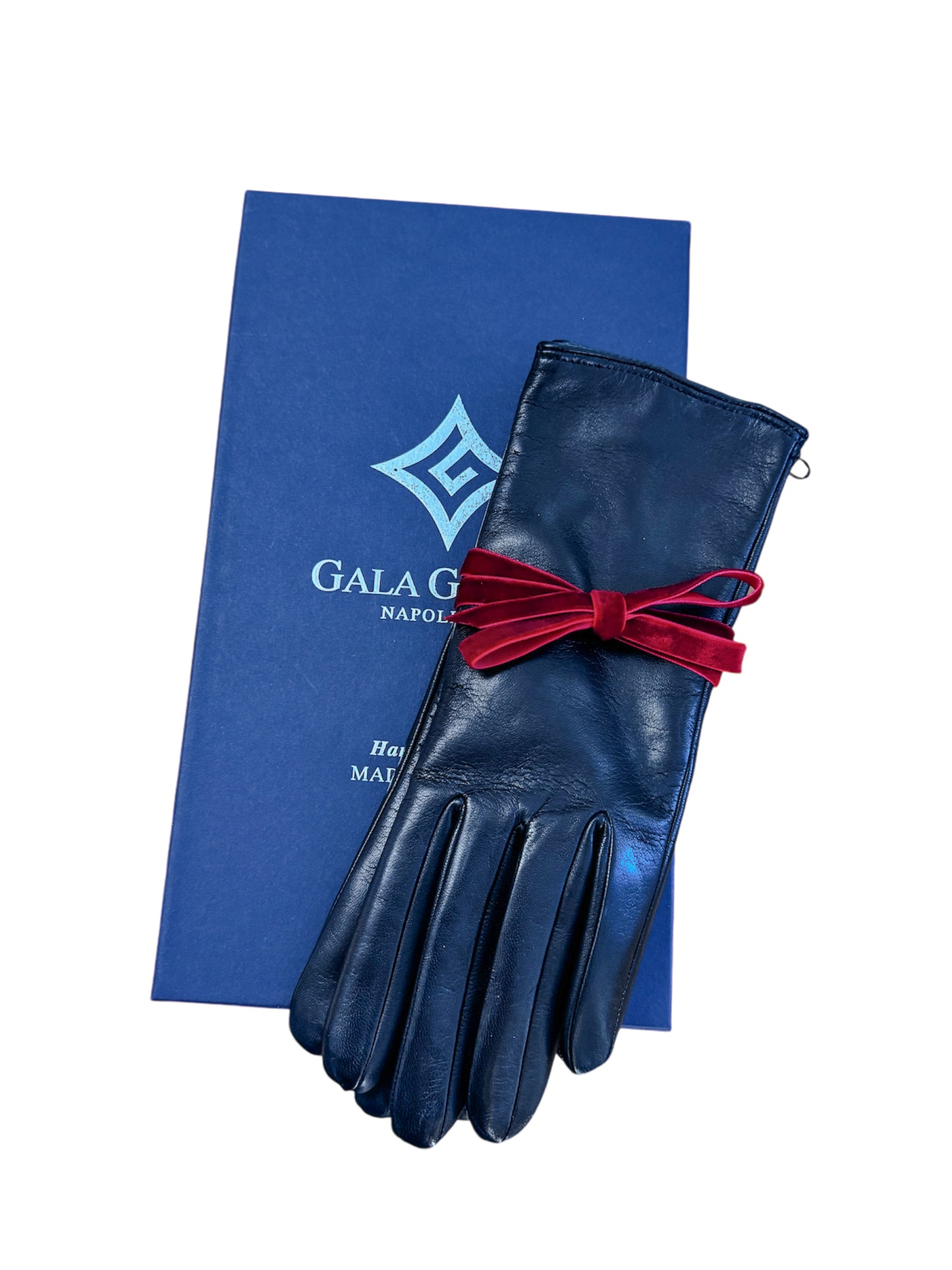 Little black leather gloves elegantly presented with a red velvet ribbon, resting on a blue Gala Gloves box.