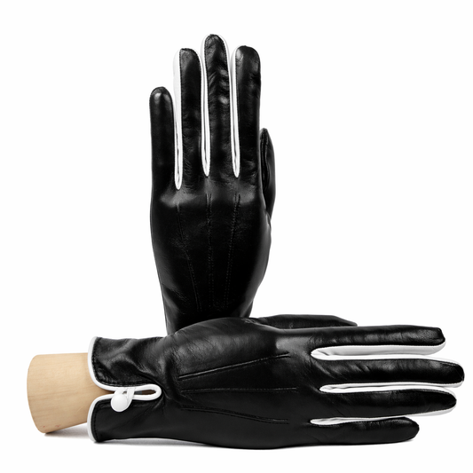 Women's black nappa leather gloves featuring elegant white detailing and a luxurious silk lining, showcasing Italian craftsmanship.