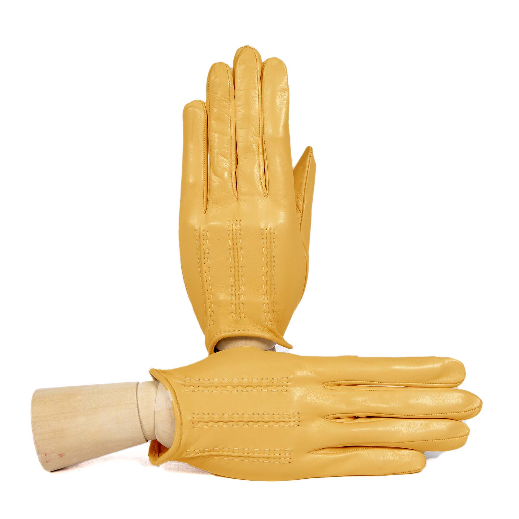 Unlined women's gloves in soft yellow leather, showcasing elegant stitching and a refined Italian design.