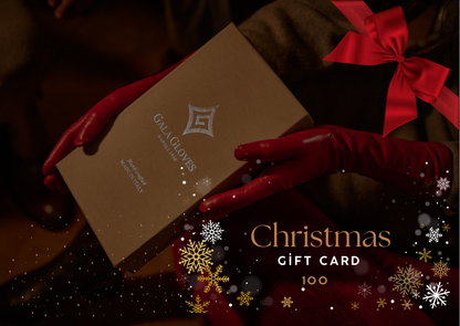 Elegant red leather gloves hold a luxurious Gala Gloves gift box, framed by festive decorations and a rich, warm background.