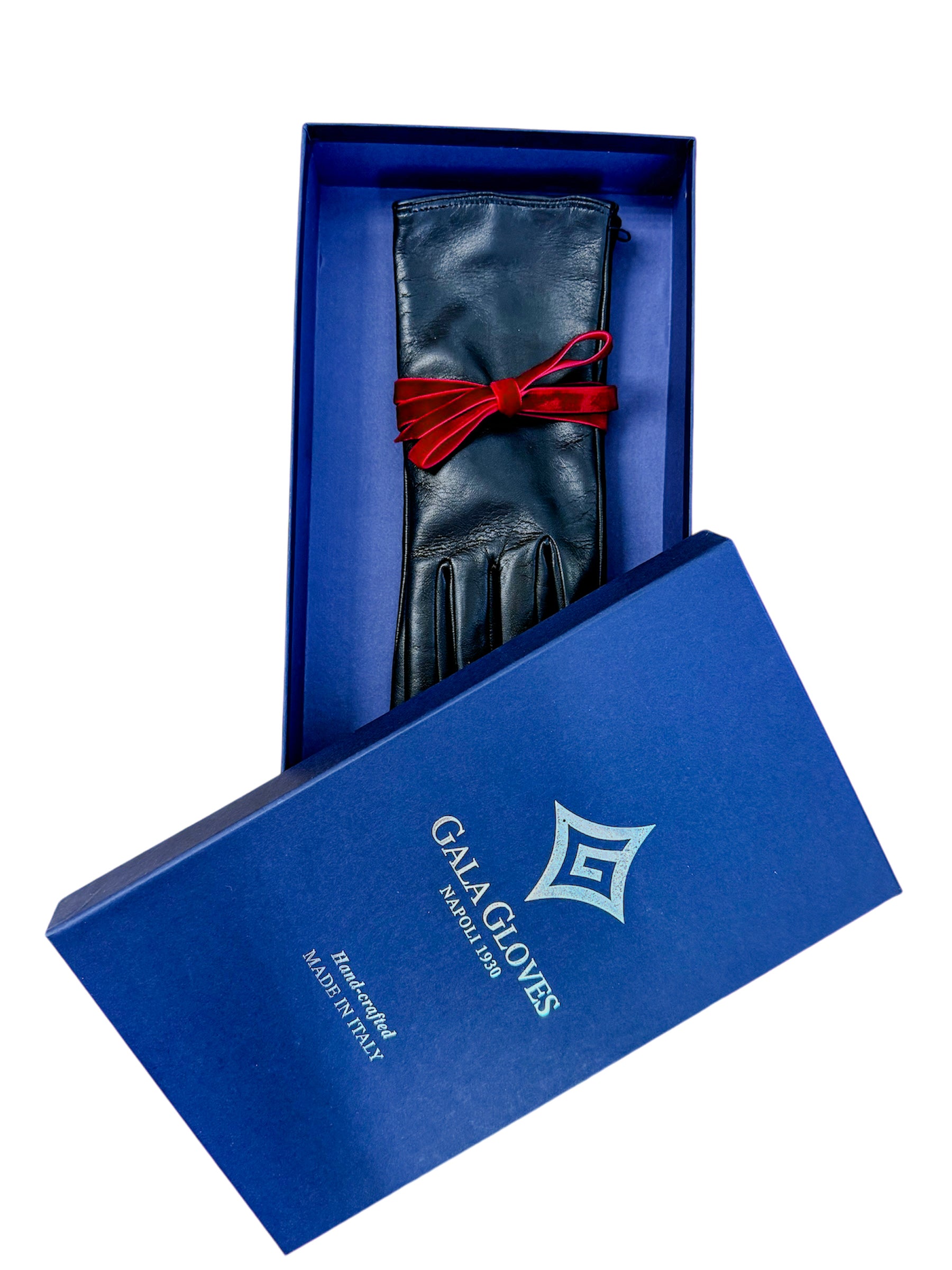 Little black leather gloves elegantly presented in a blue box, tied with a red ribbon, showcasing Italian craftsmanship.