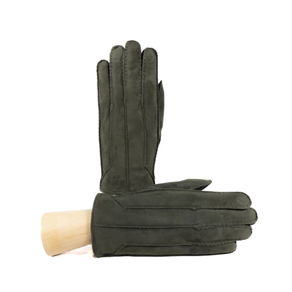 Handcrafted dark green suede leather gloves with elegant stitching, showcasing Italian craftsmanship and luxurious design.