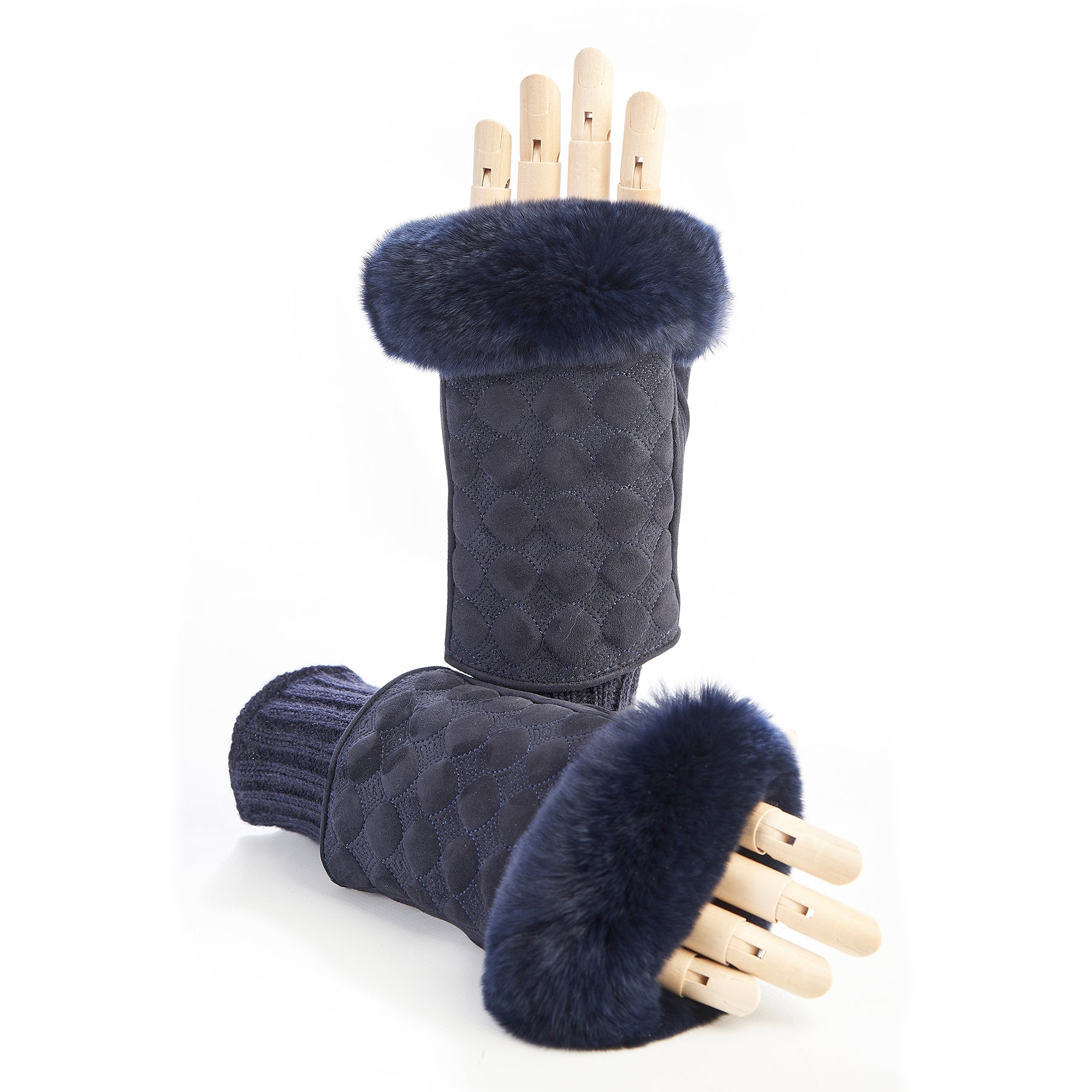 Navy suede fingerless gloves with a plush fur cuff, showcasing elegant Italian craftsmanship and luxurious materials.